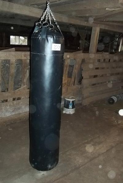 KO Muay Thai Bag hanging in a barn