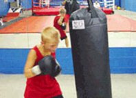 Young boxer punching the KO Heavy Bag